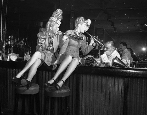 Women Sitting on Bar with Bartender